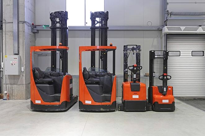 workers using forklifts to move materials